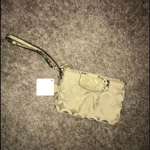 Brand new Coach wristlet with tags on it! Snakeskin trim